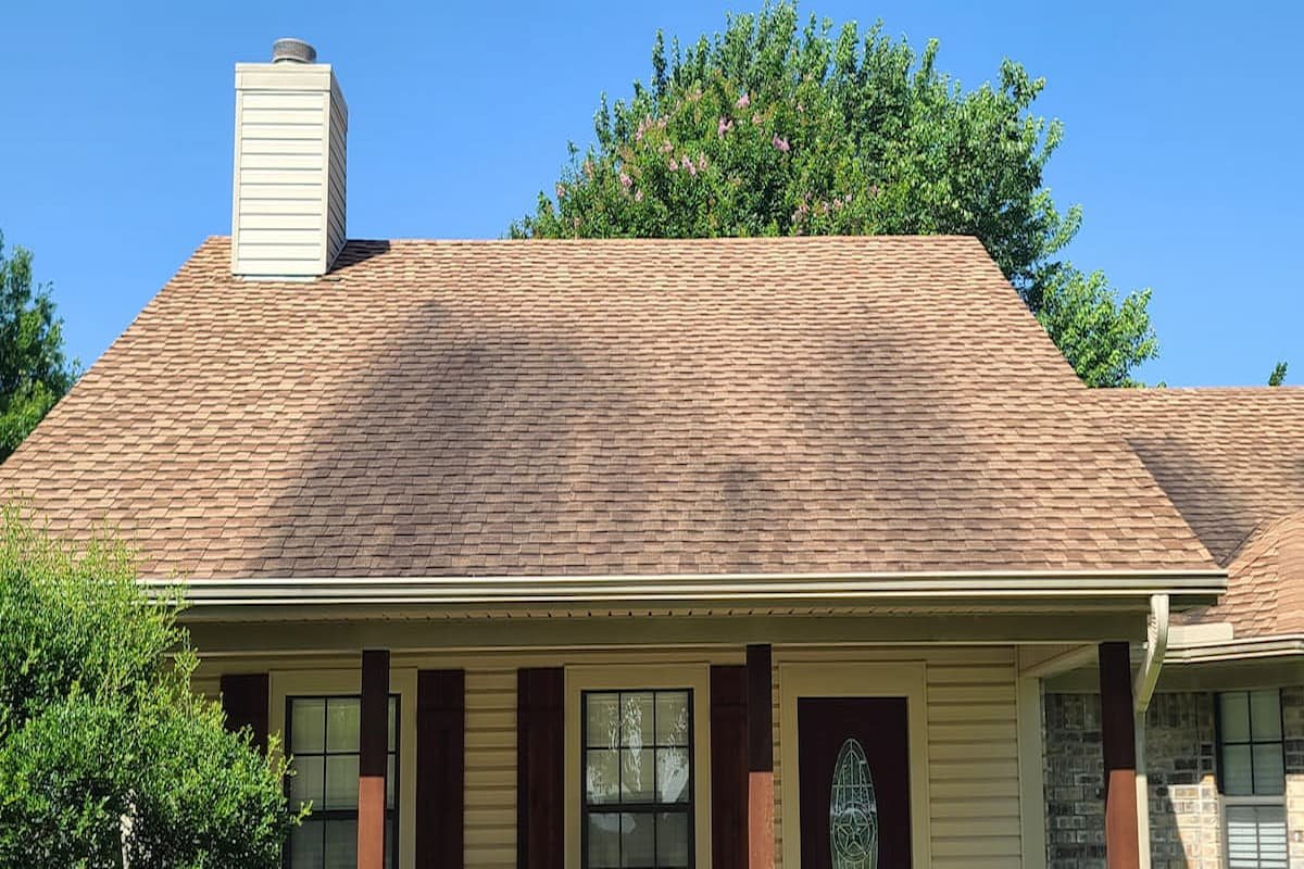 Roof before cleaning in Corsicana TX showing black algae stains on asphalt shingles