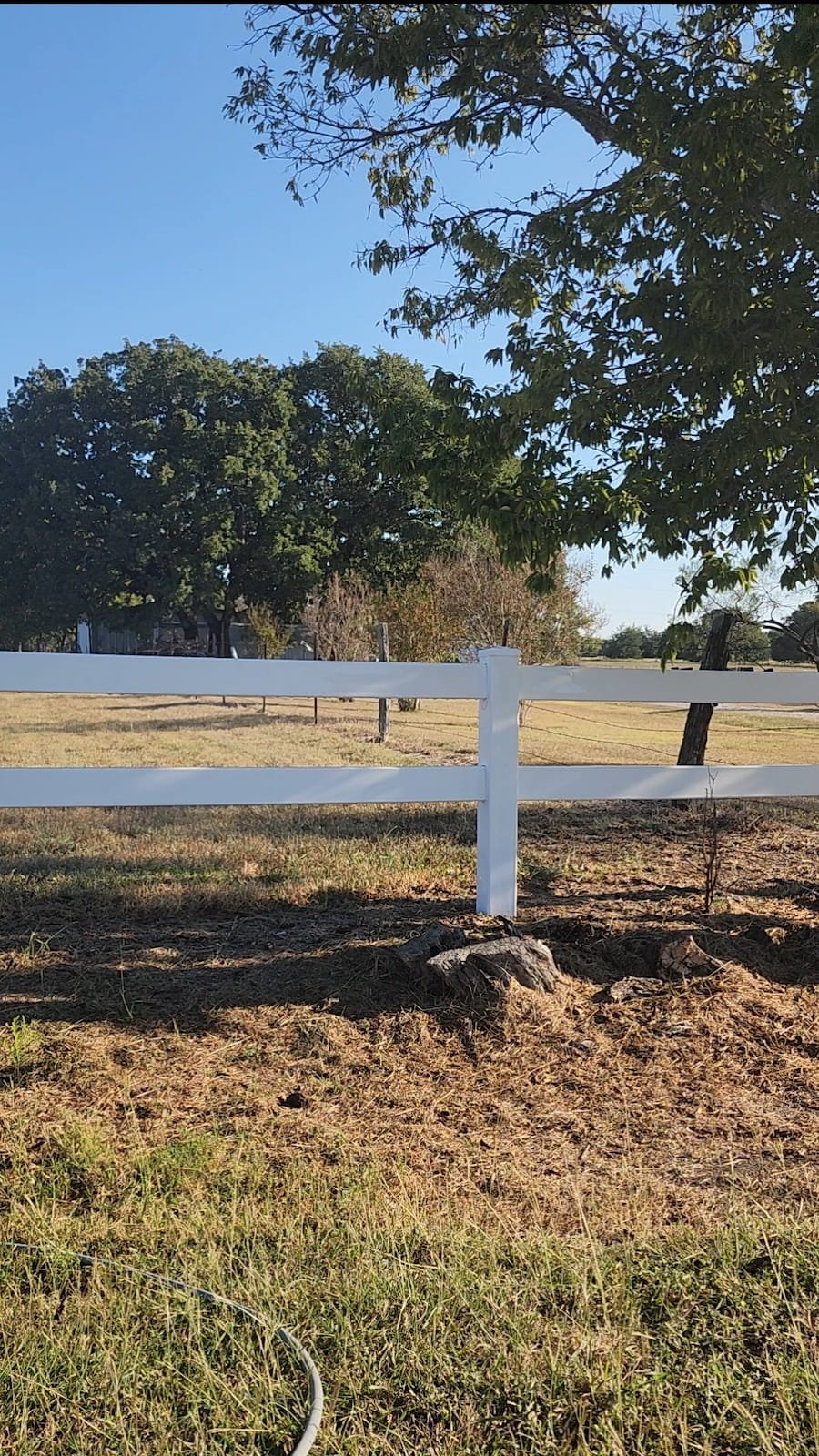 Vinyl fence after cleaning in Corsicana TX showing restored clean fence planks