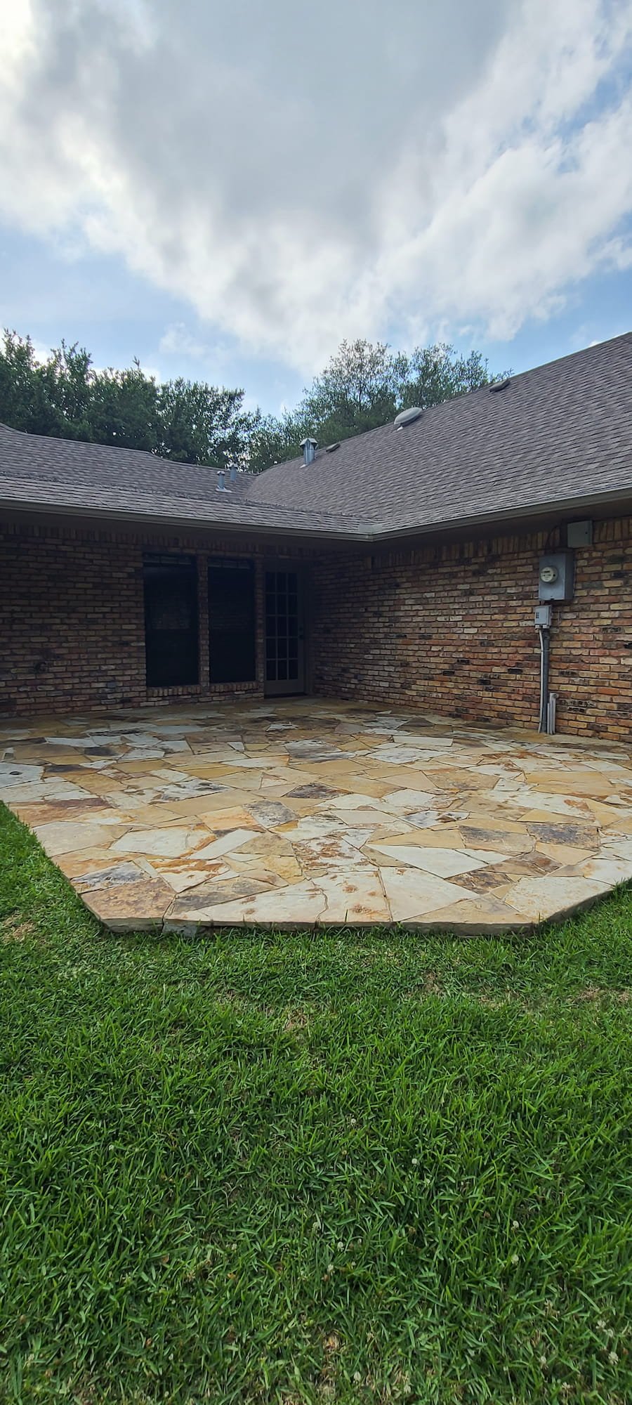Clean natural stone patio after professional pressure washing in Corsicana Texas