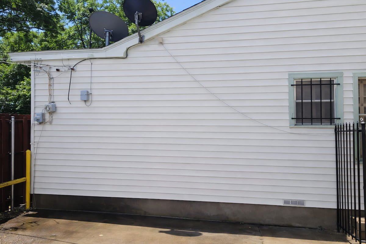 Clean white vinyl siding after professional house washing in Corsicana Texas