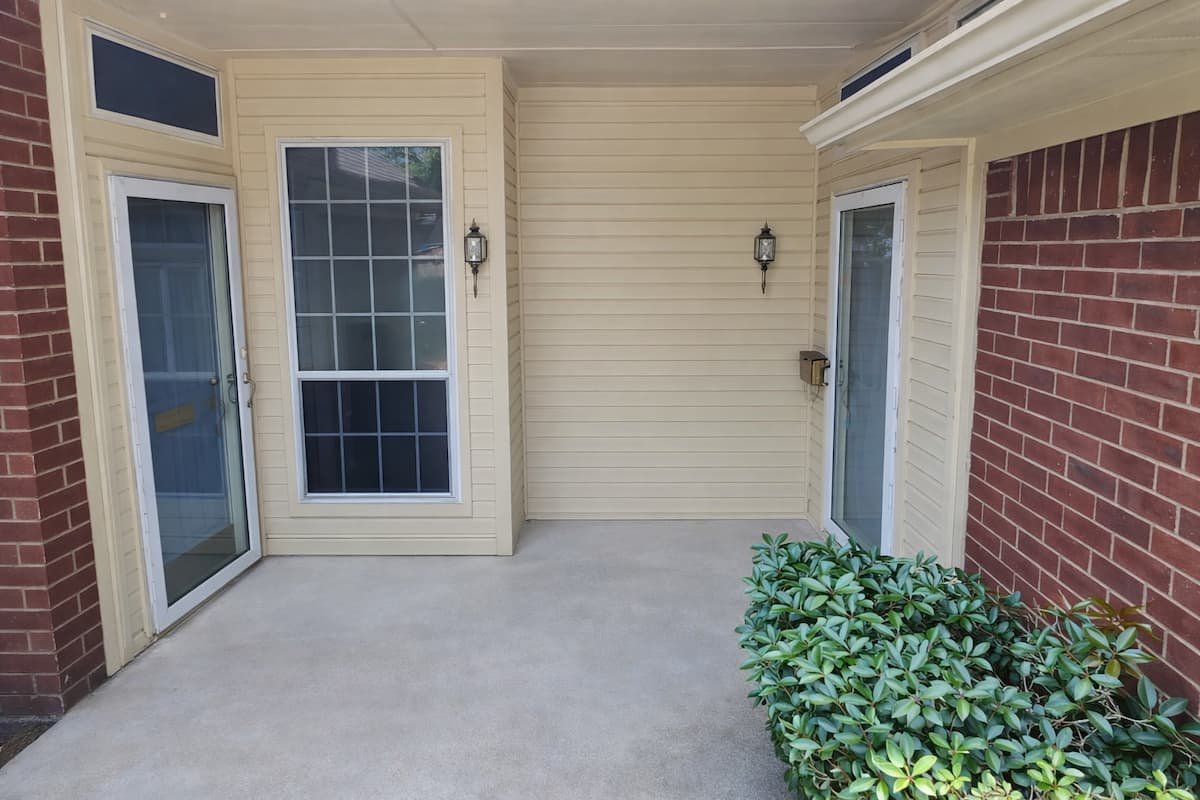 Clean vinyl siding and entryway after professional house washing in Corsicana Texas