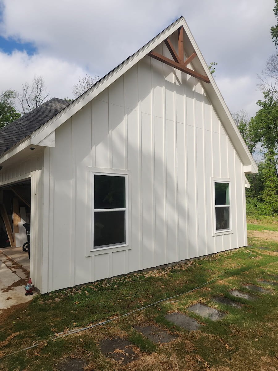 House washing in Corsicana TX restoring siding, trim, and soffits on painted Hardie board exterior