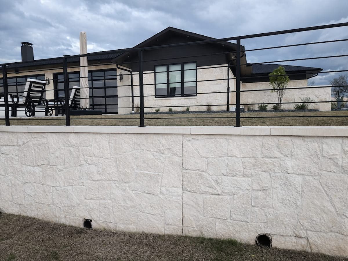 Clean stone retaining wall after rust stain removal in Streetman Texas