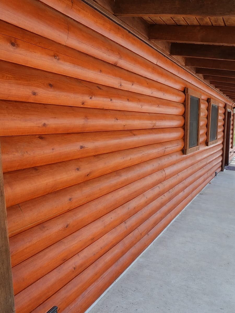 House washing after cleaning in Streetman TX showing clean log siding exterior